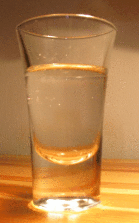 Ice melting in a glass, played in reverse